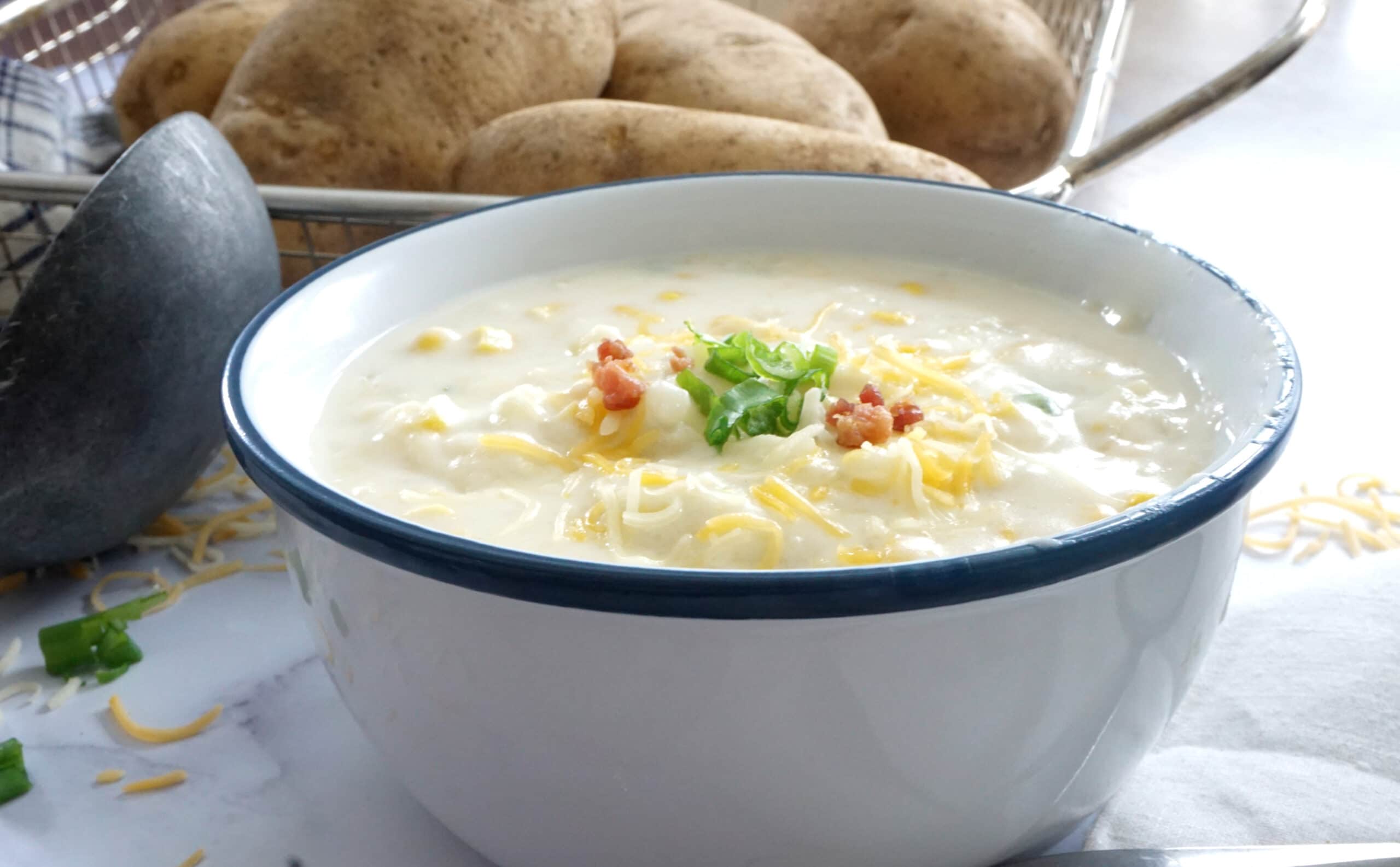 bowl of southern baked potato soup with toppings
