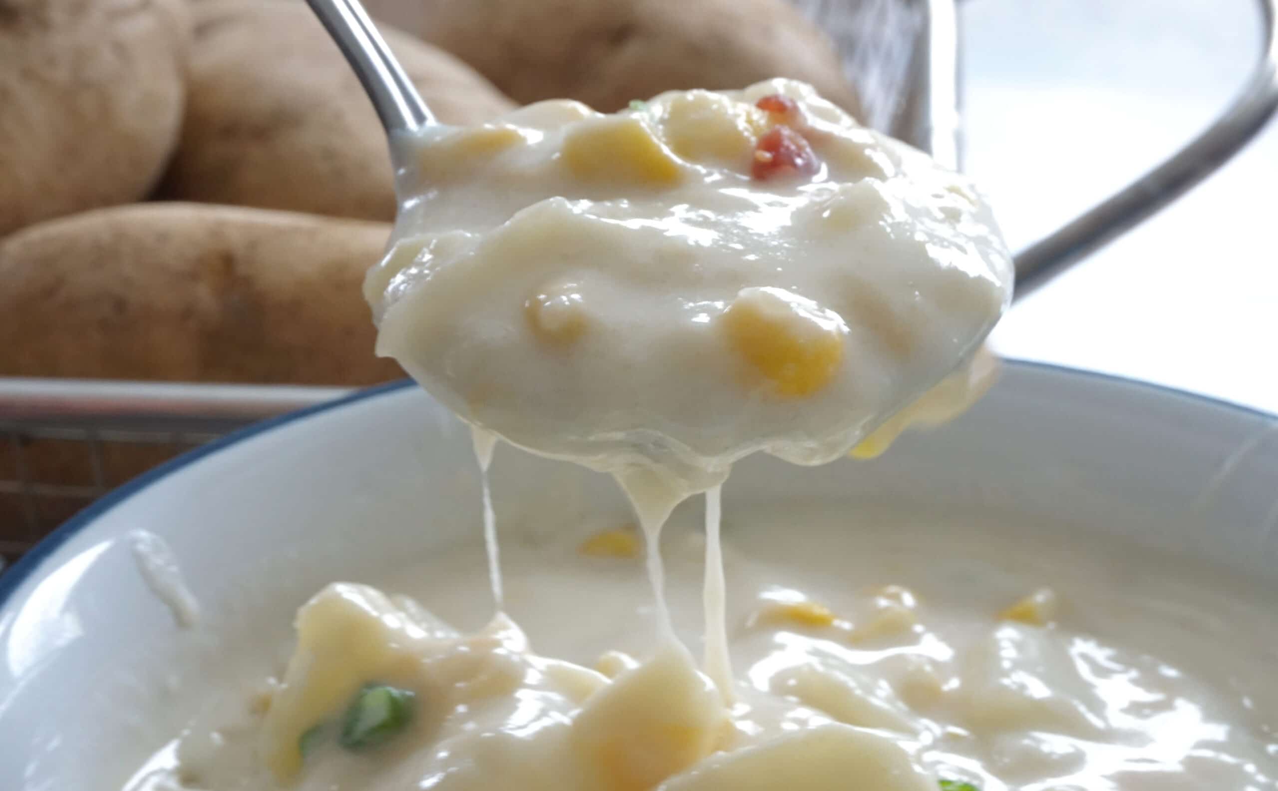 potato soup dripping with cheese from a spoon