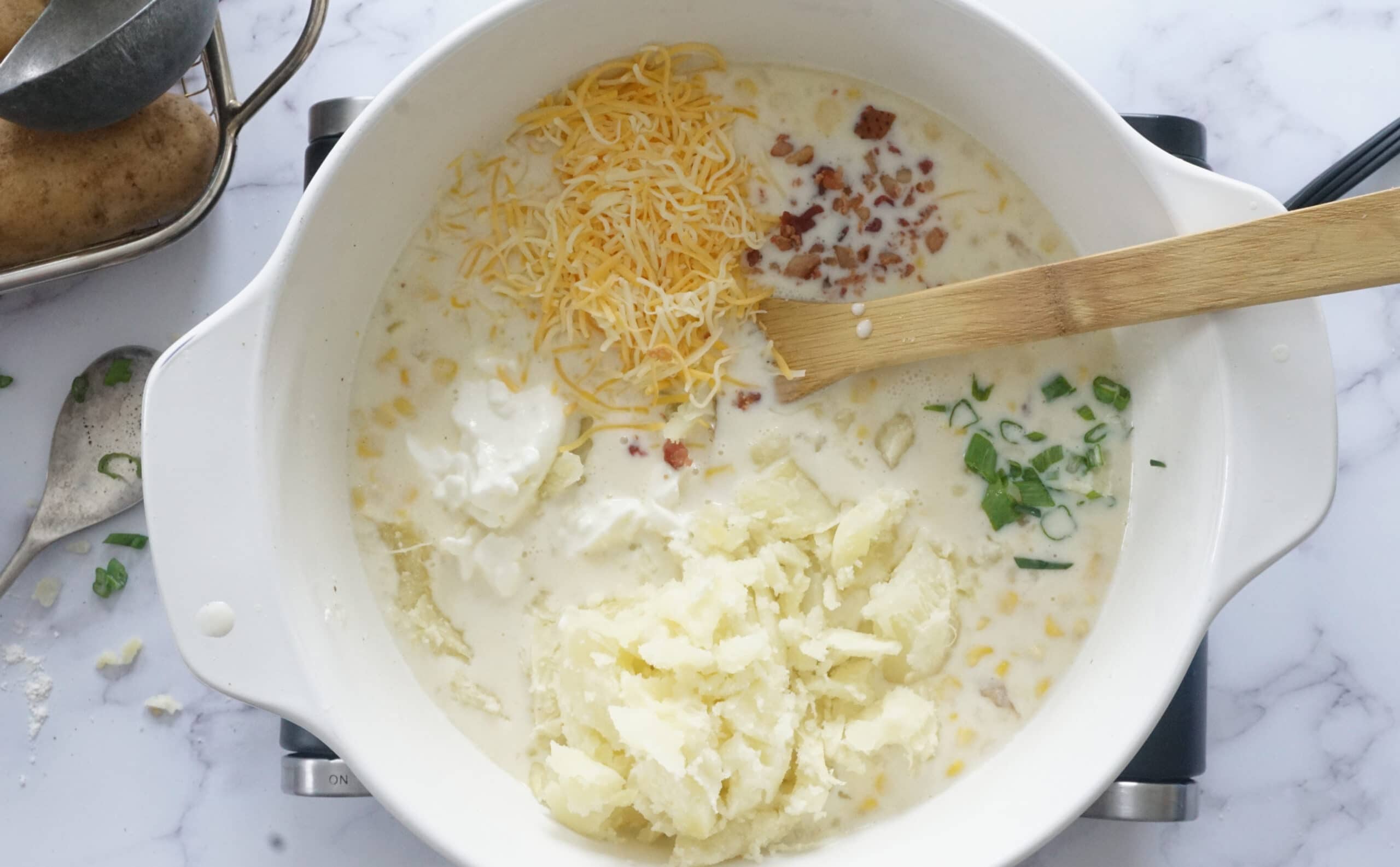 baked potato soup with sour cream, bacon, cheese and green onions