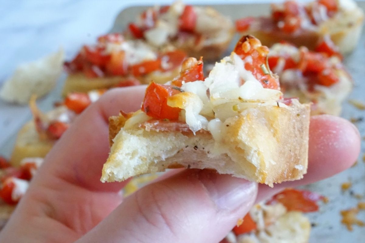 bruschetta appetizer in hand