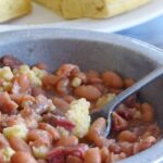 cooked soup beans and ham with cornbreadin a bowl