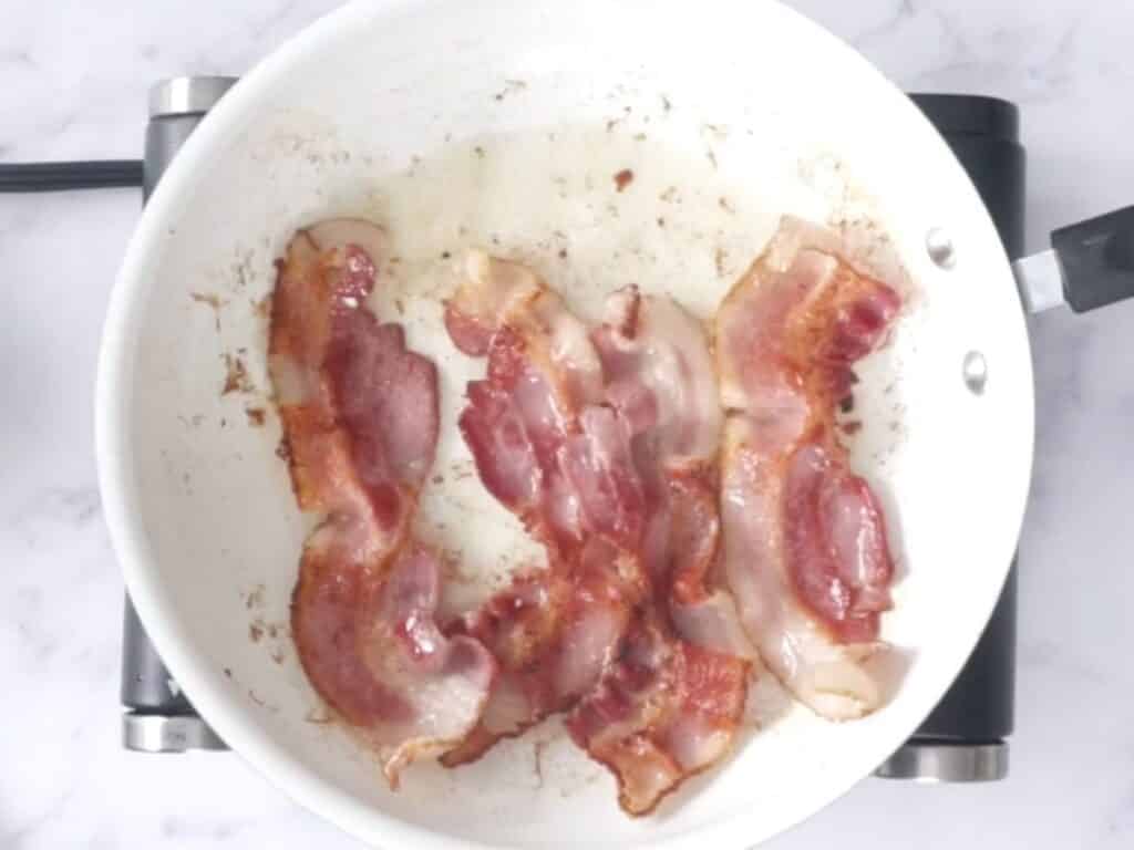 frying bacon in a pan