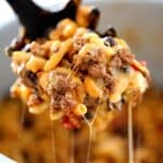 instant pot chili mac n cheese being lifted from pot with cheese strings