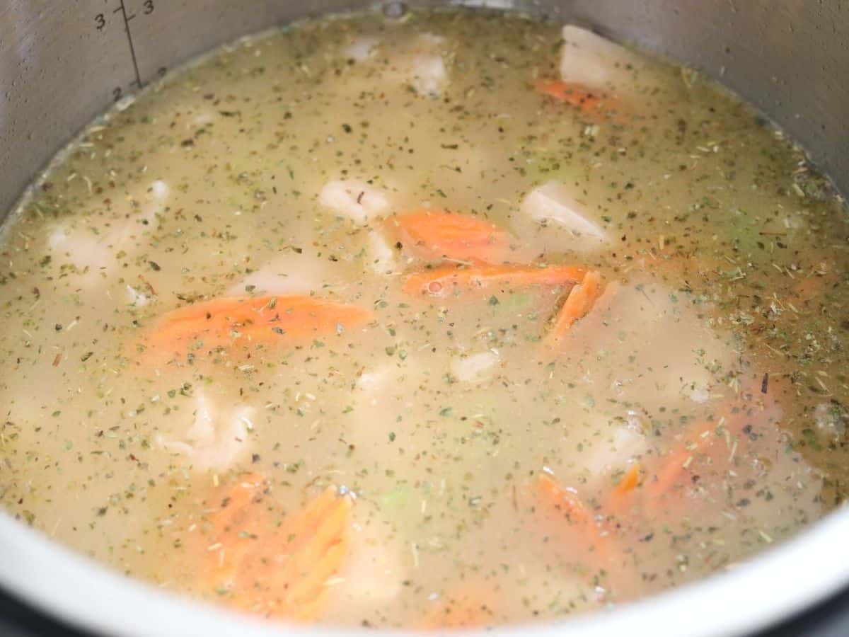 adding chicken stock and chicken breasts