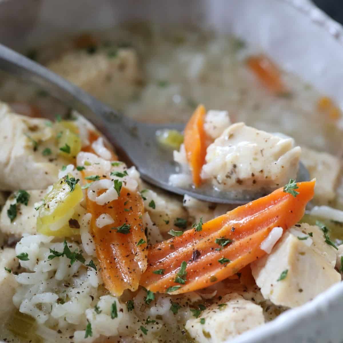 instant pot chicken and rice soup in a bowl with spoon