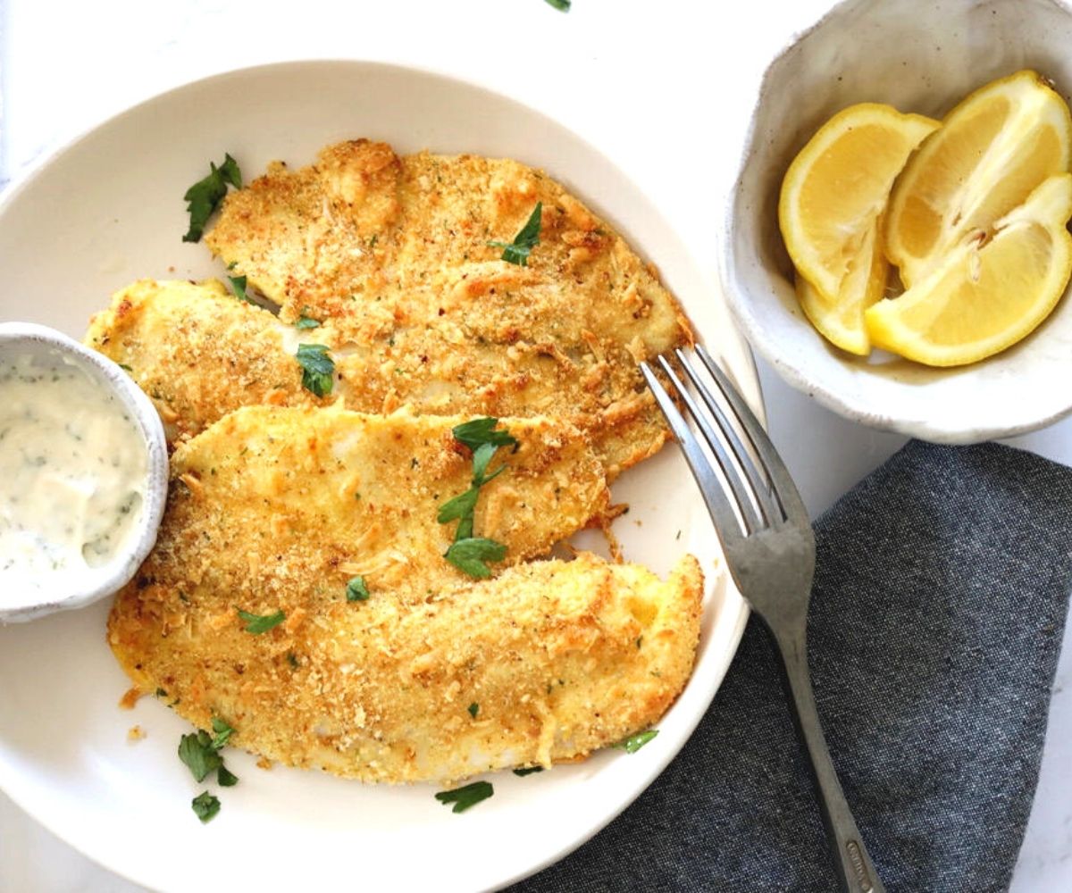 tilapia with lemon wedge and tartar sauce