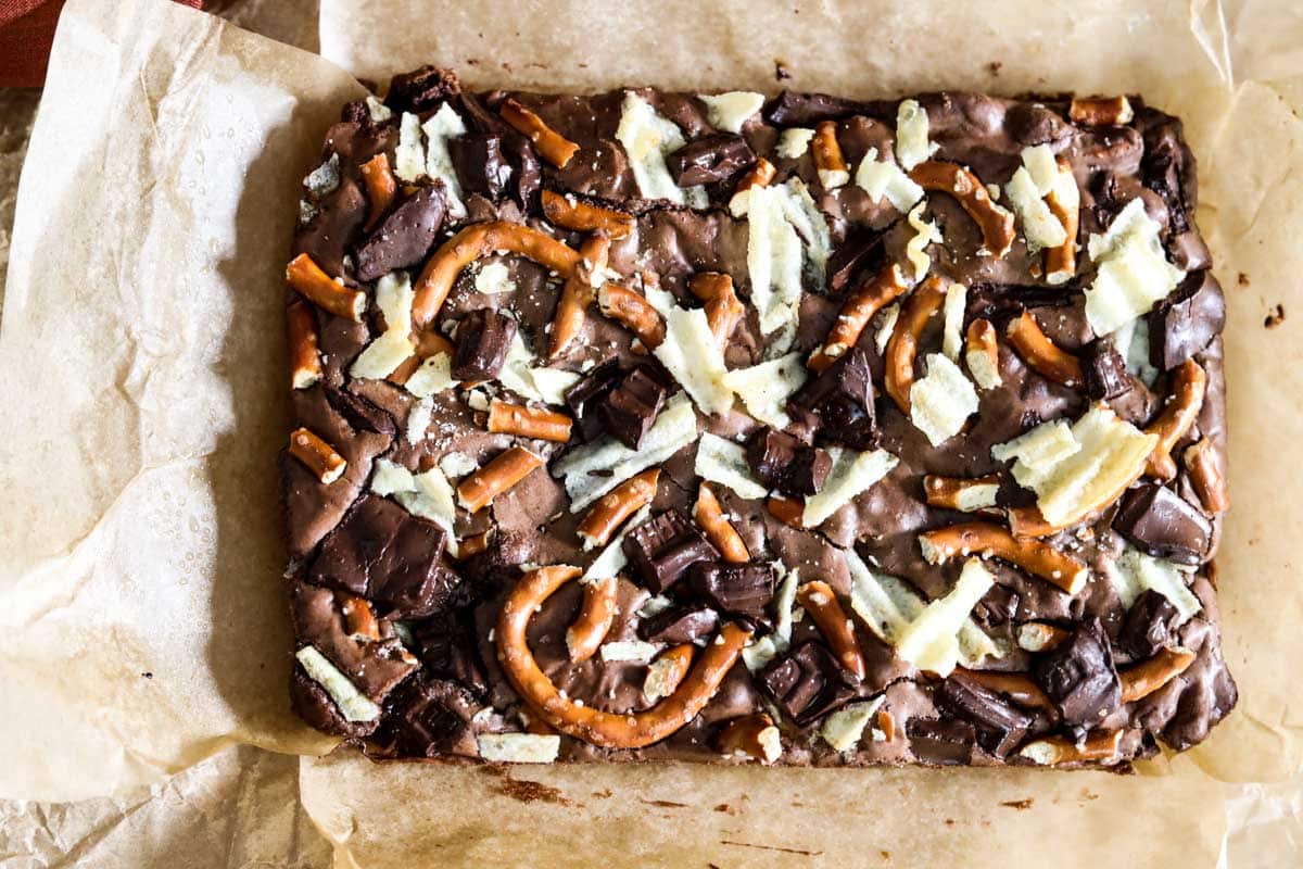 sheet of brownies atop parchment paper