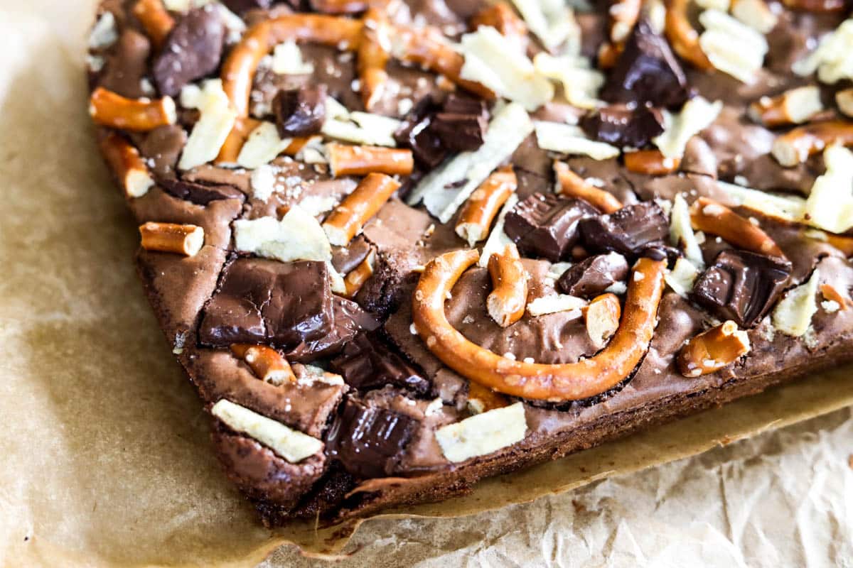 sweet and salty bits with brownies on parchment paper