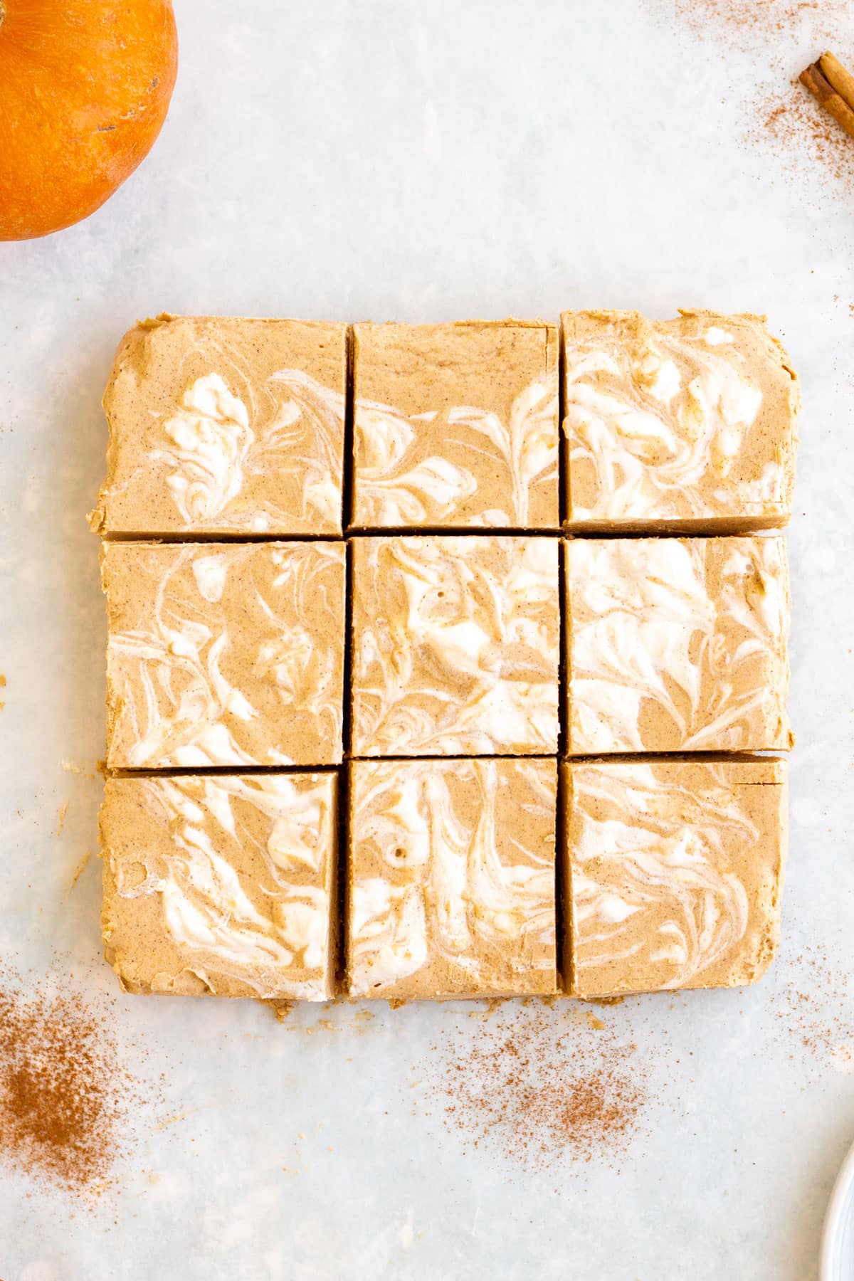 9x9 inch dish with pumpkin cheesecake and swirls on top