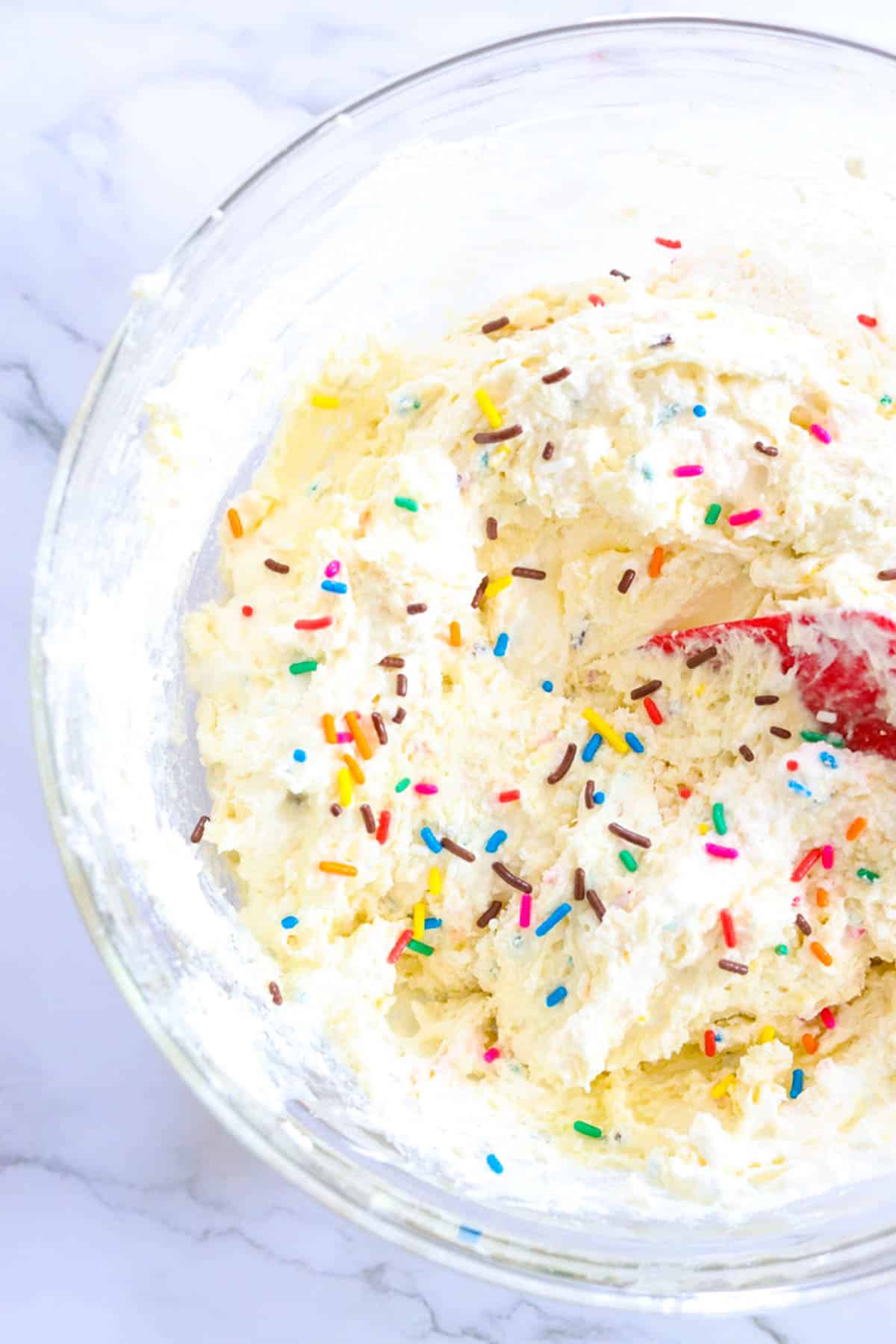 mixing dip in a bowl with sprinkles