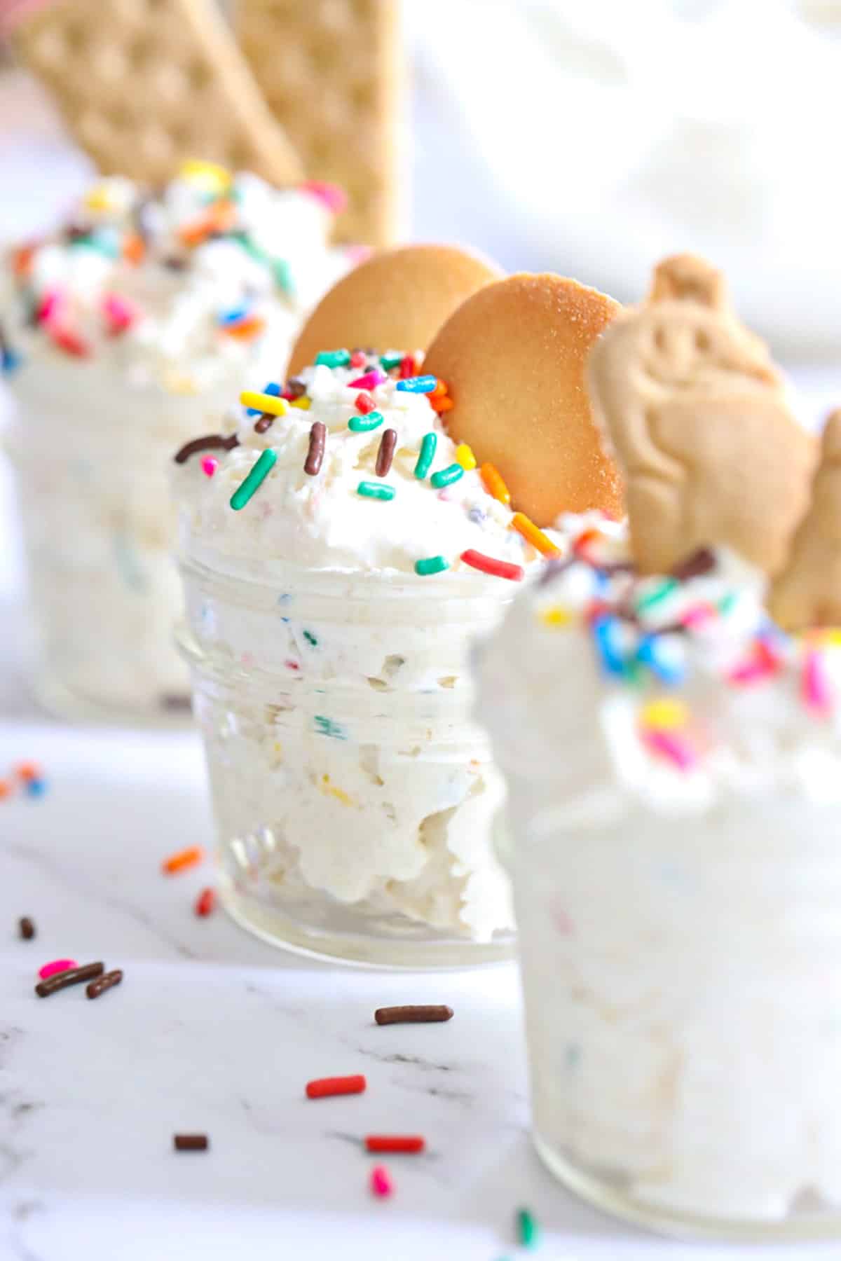 tiny glass jars with dunkaroo dip inside and sprinkles on top