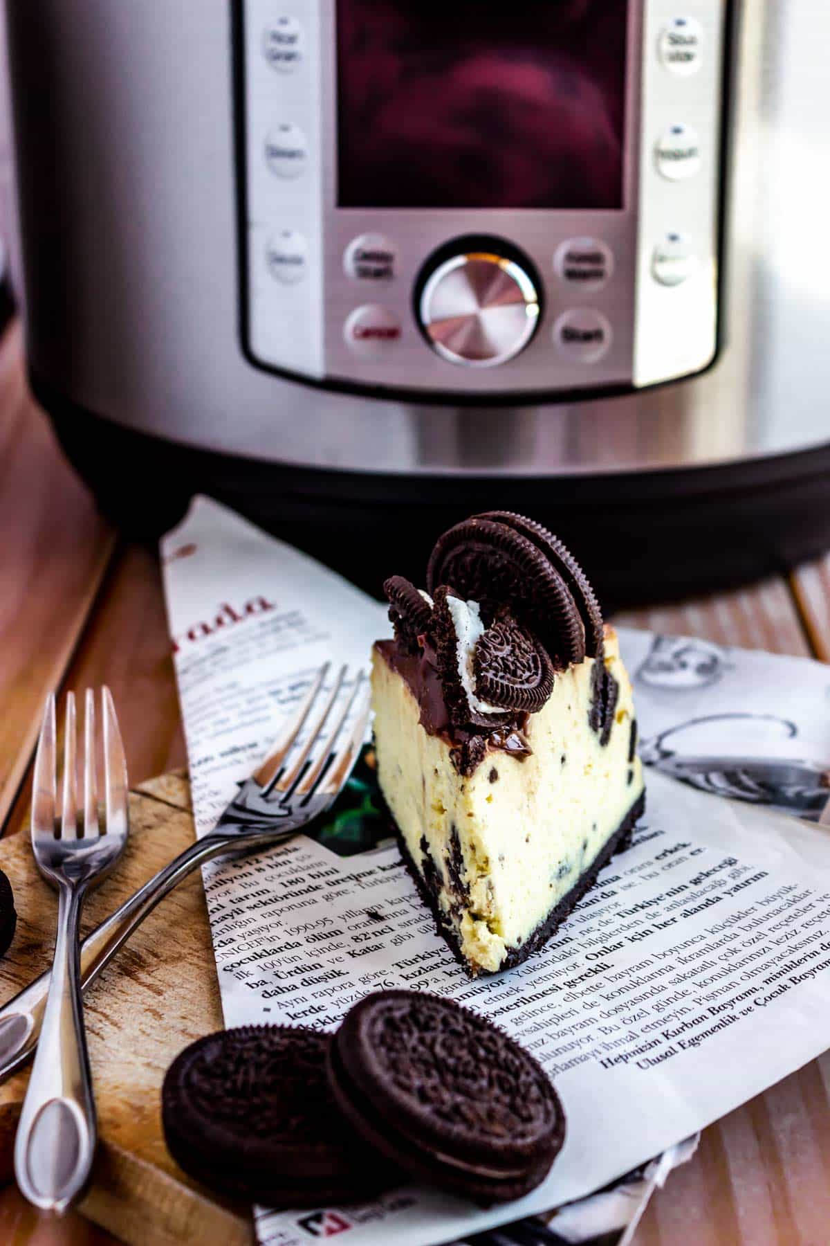 cookies with a slice of cheesecake in front of the instant pot