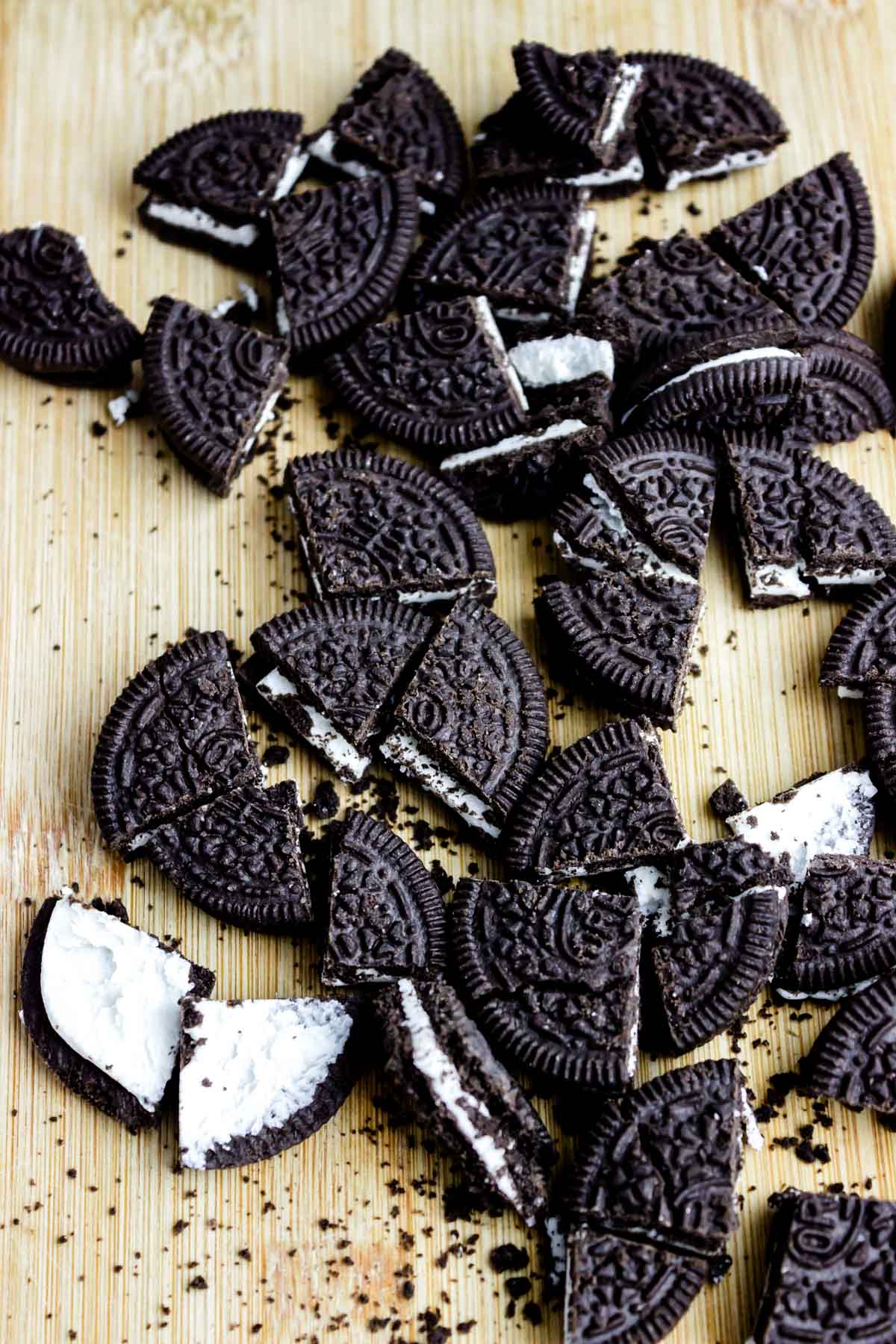 a bunch of crumbled Oreo cookies with creamy filling crushed on a table