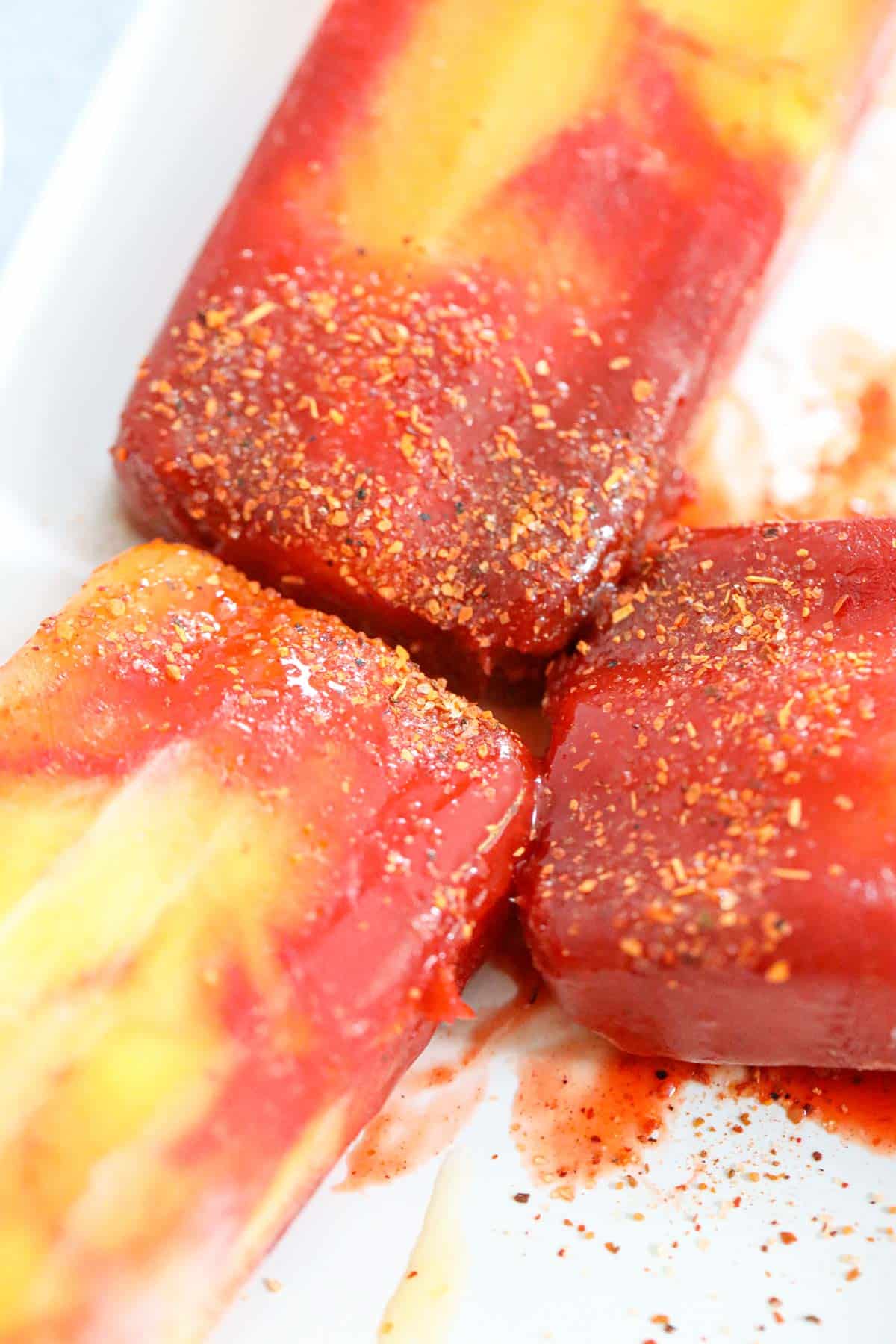 mangonada pops covered in chili lime and chamoy