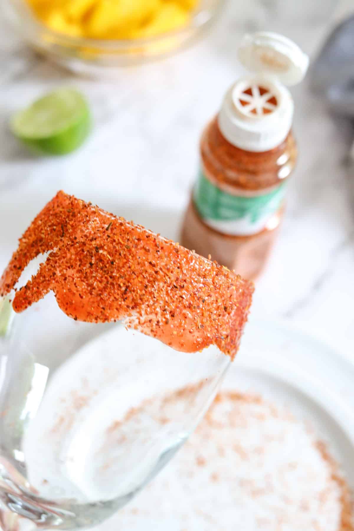 rimming a glass with chamoy and Tajin