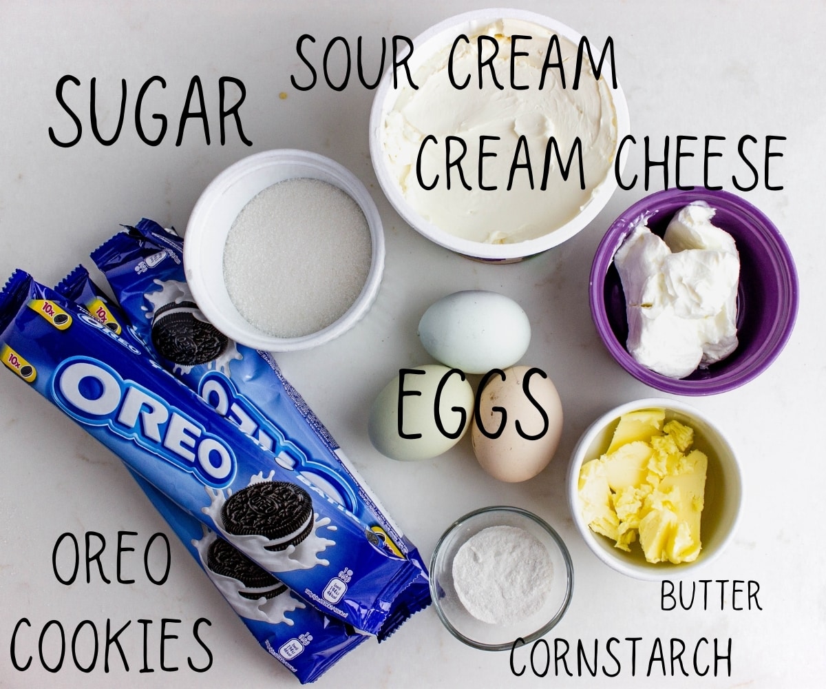 ingredients for oreo cheesecake laid out on a table