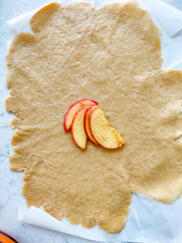 arranging apple slices onto the crust