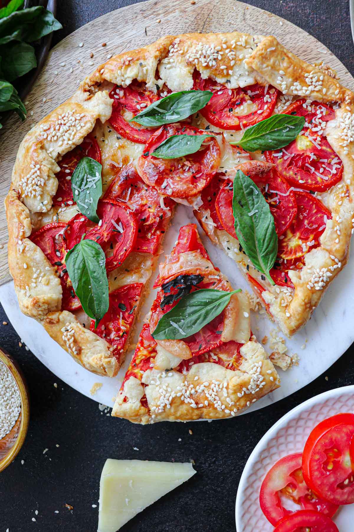 cutting a piece from tomato galette