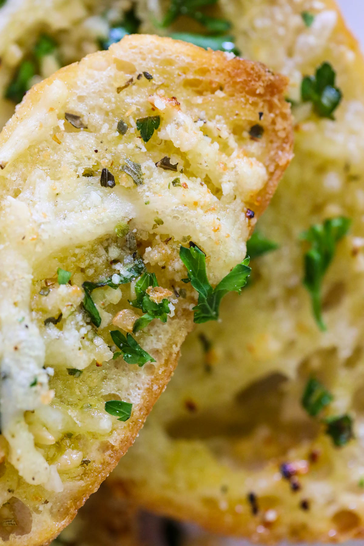 close up of garlic bread with cheese and Italian seasoning blend
