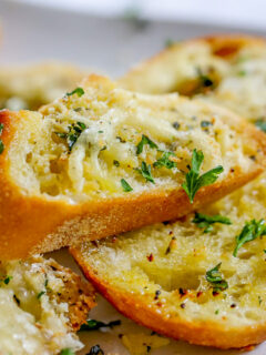 slices of garlic bread with cheese and seasonings