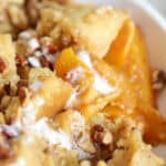 up close view of peach bread pudding with candied walnuts