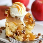 apple bread pudding with nut topping and ice cream dripping down the side