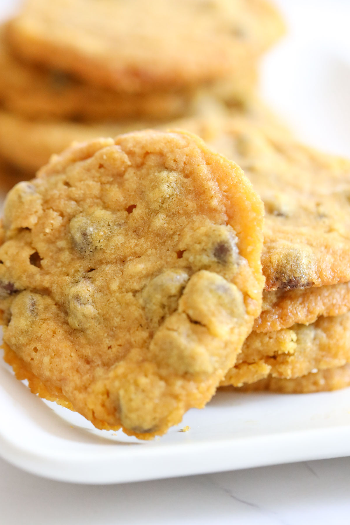 Cookie on its side next to a stack of pumpkin cookies