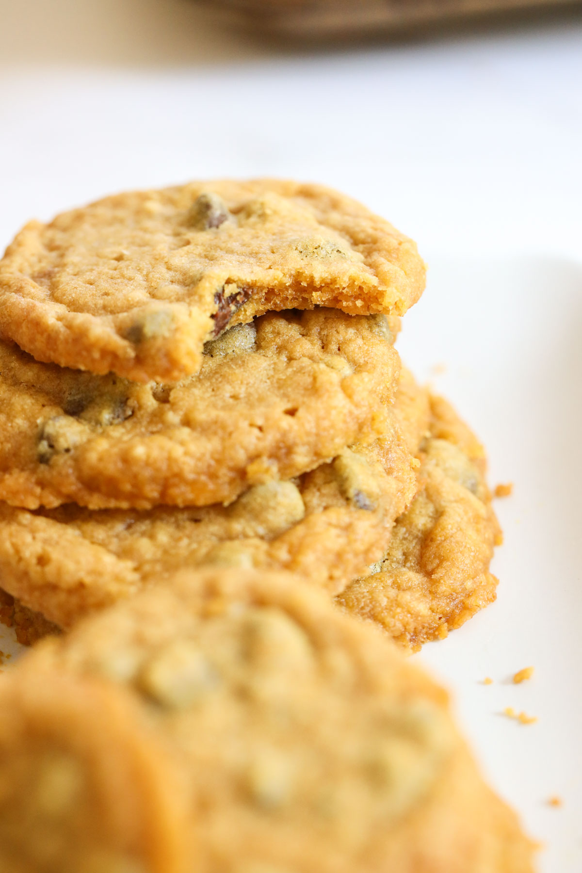 Pumpkin cookies stacked with a bite taken from one on top