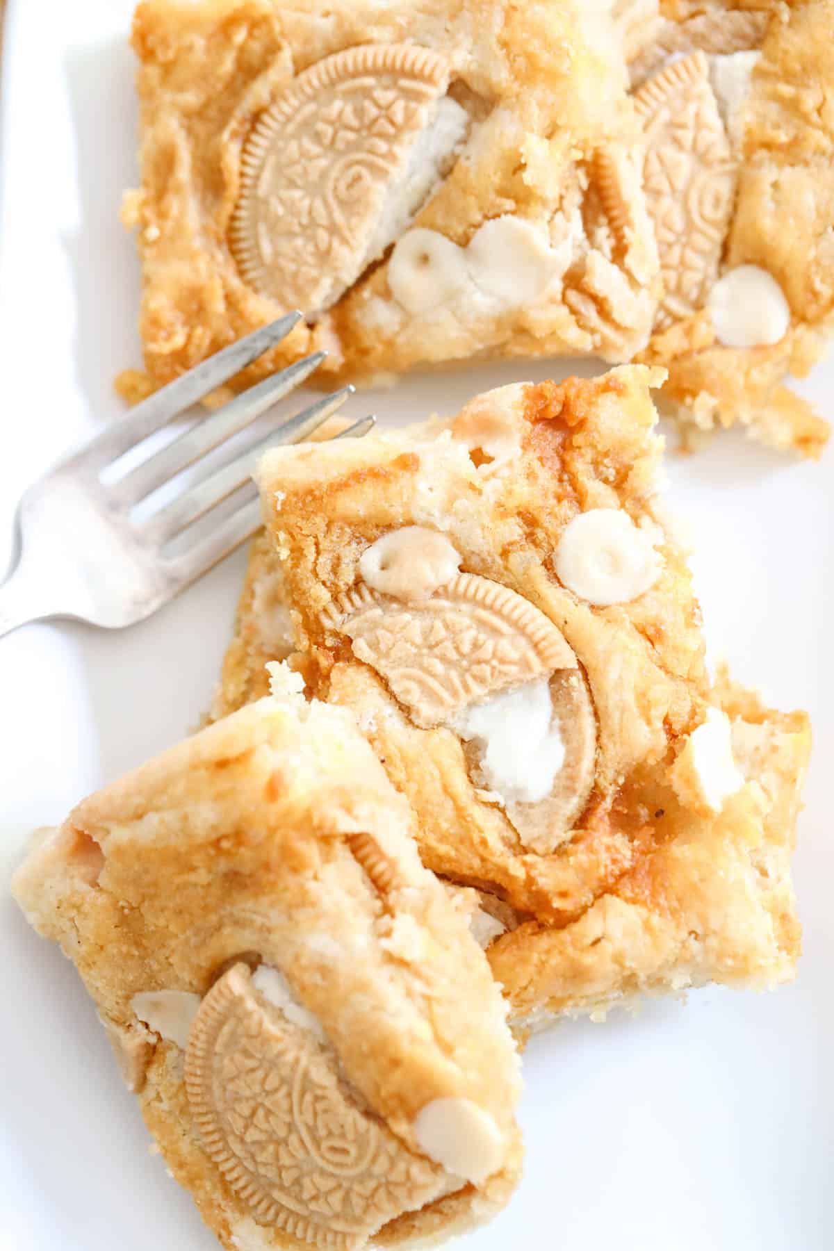 Pumpkin blondies with Oreo cookie chunks and a fork on a plate