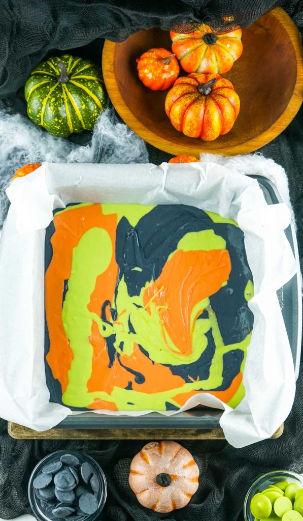 alternate pouring colors into a pan lined with parchment paper
