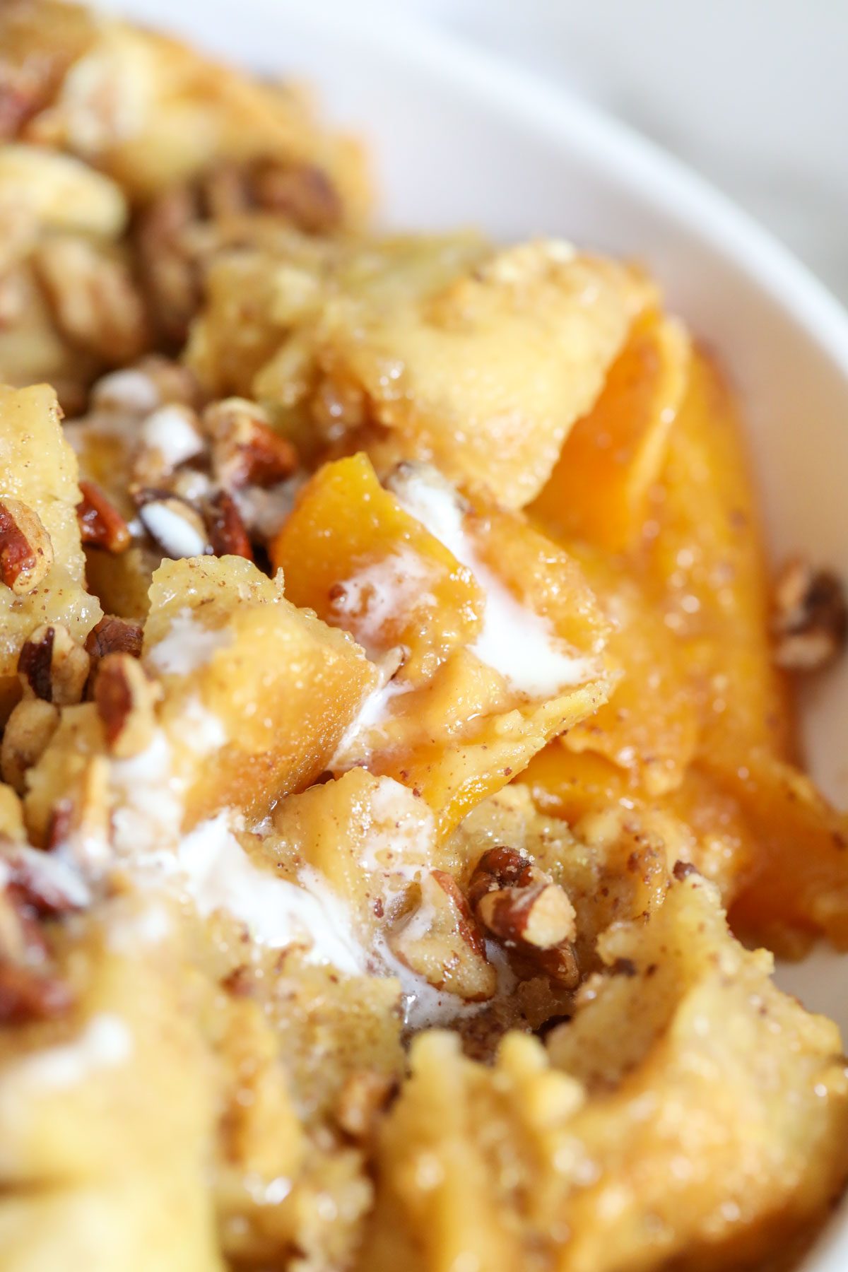 up close view of peach bread pudding with candied walnuts
