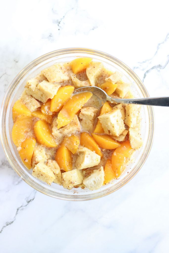 peaches and bread mixture soaking in a bowl