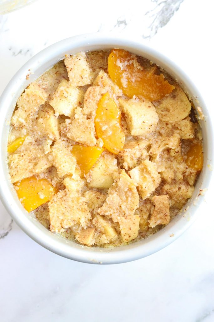 adding batter to pan with peaches and bread