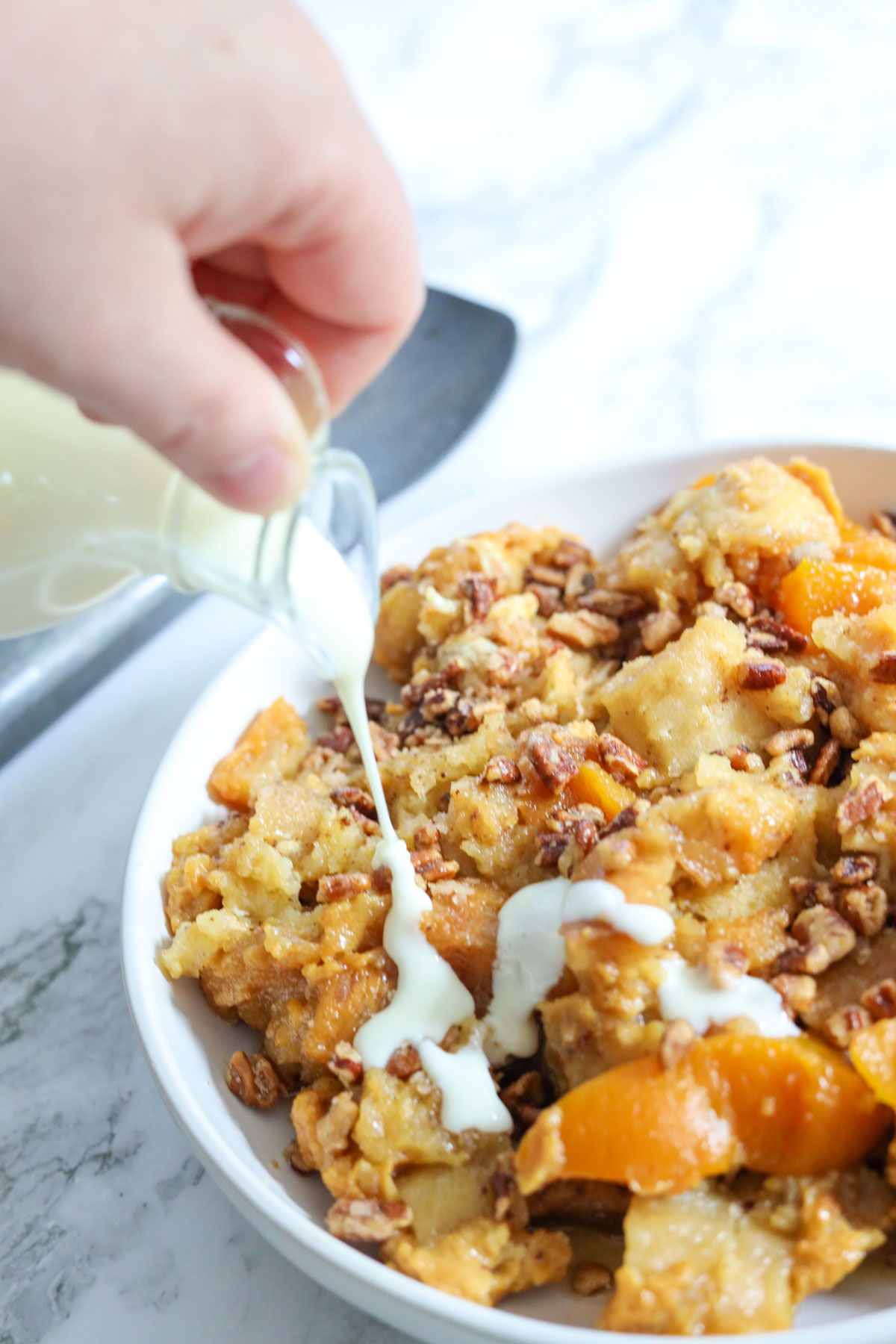drizzled icing on peach bread pudding