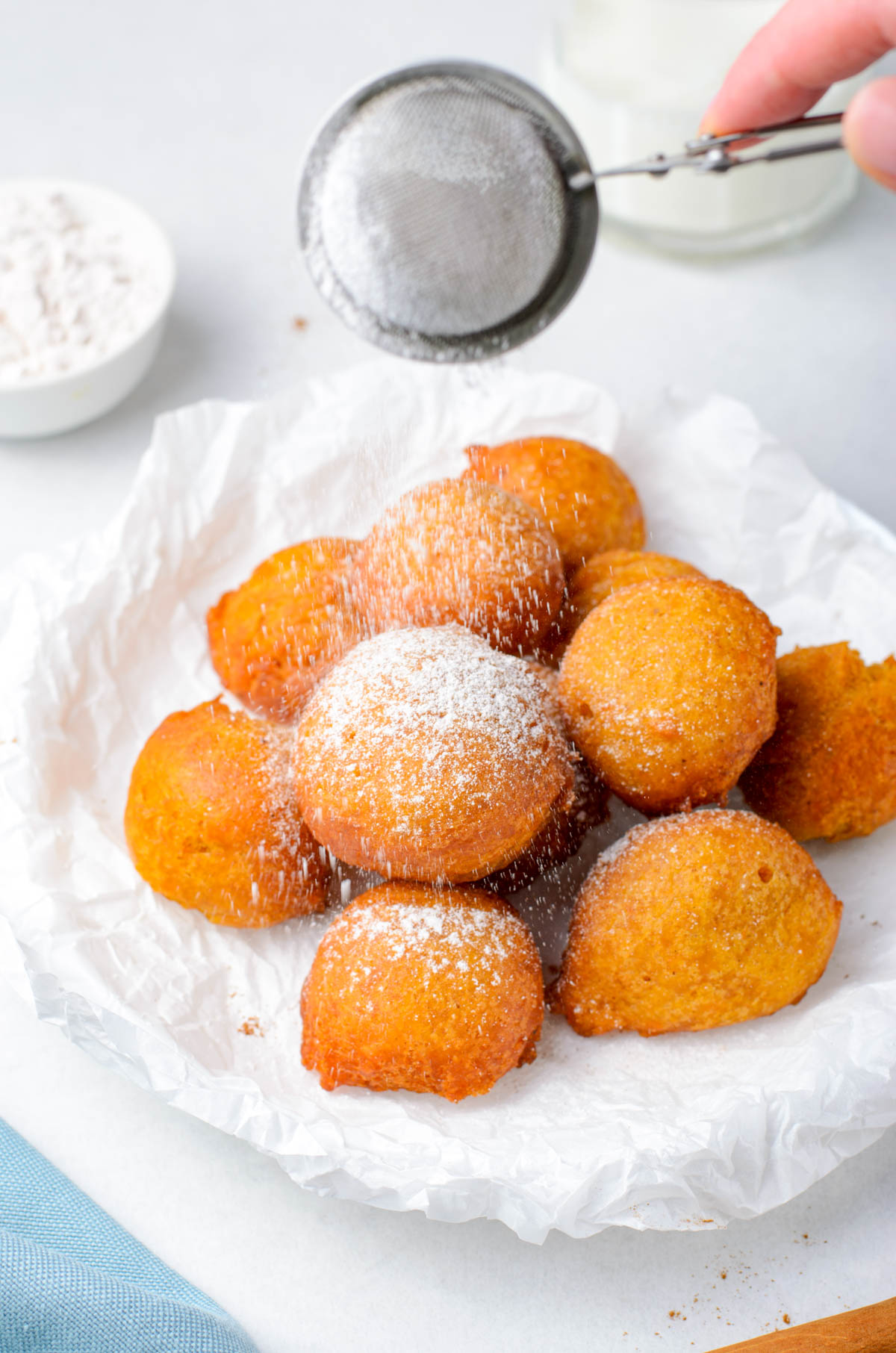 adding powdered sugar to fritters