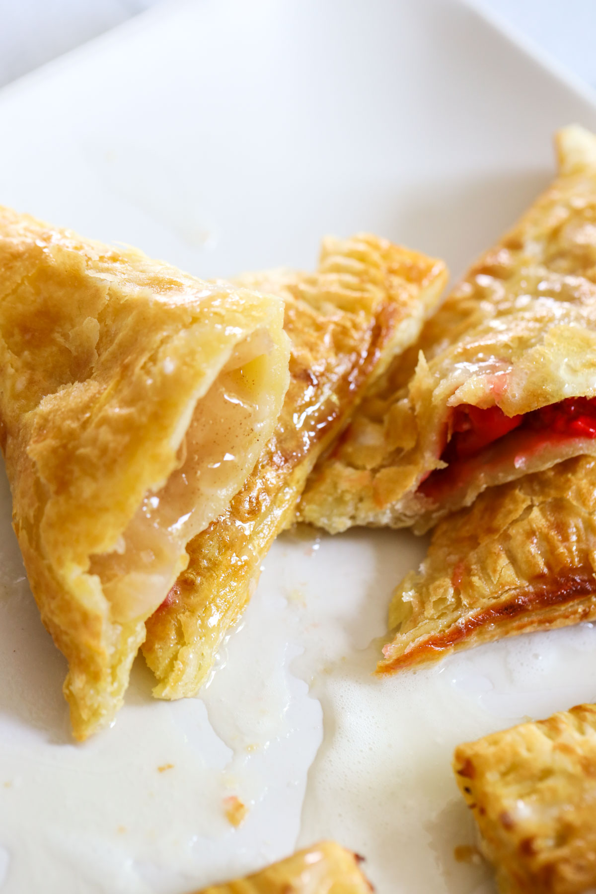 apple air fryer turnover with golden crust resting on other turnovers