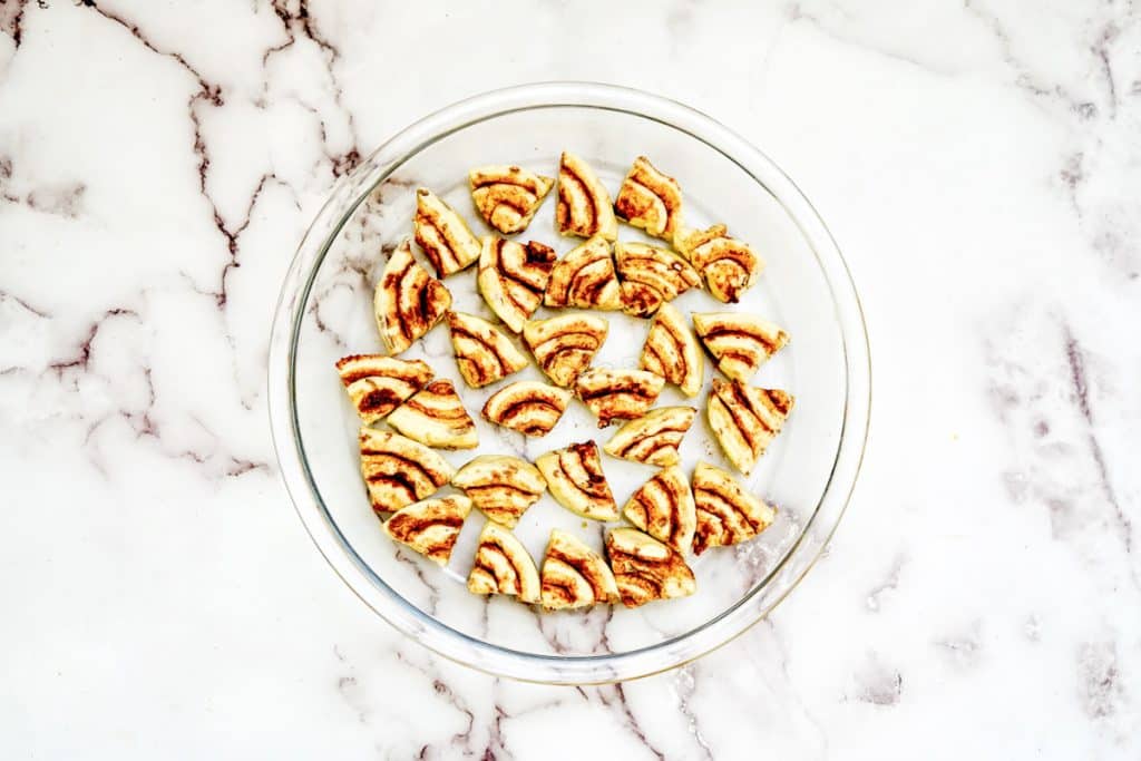 adding cinnamon rolls to pan