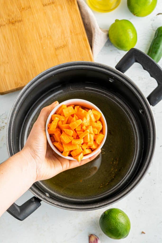 adding carrots to a large pot