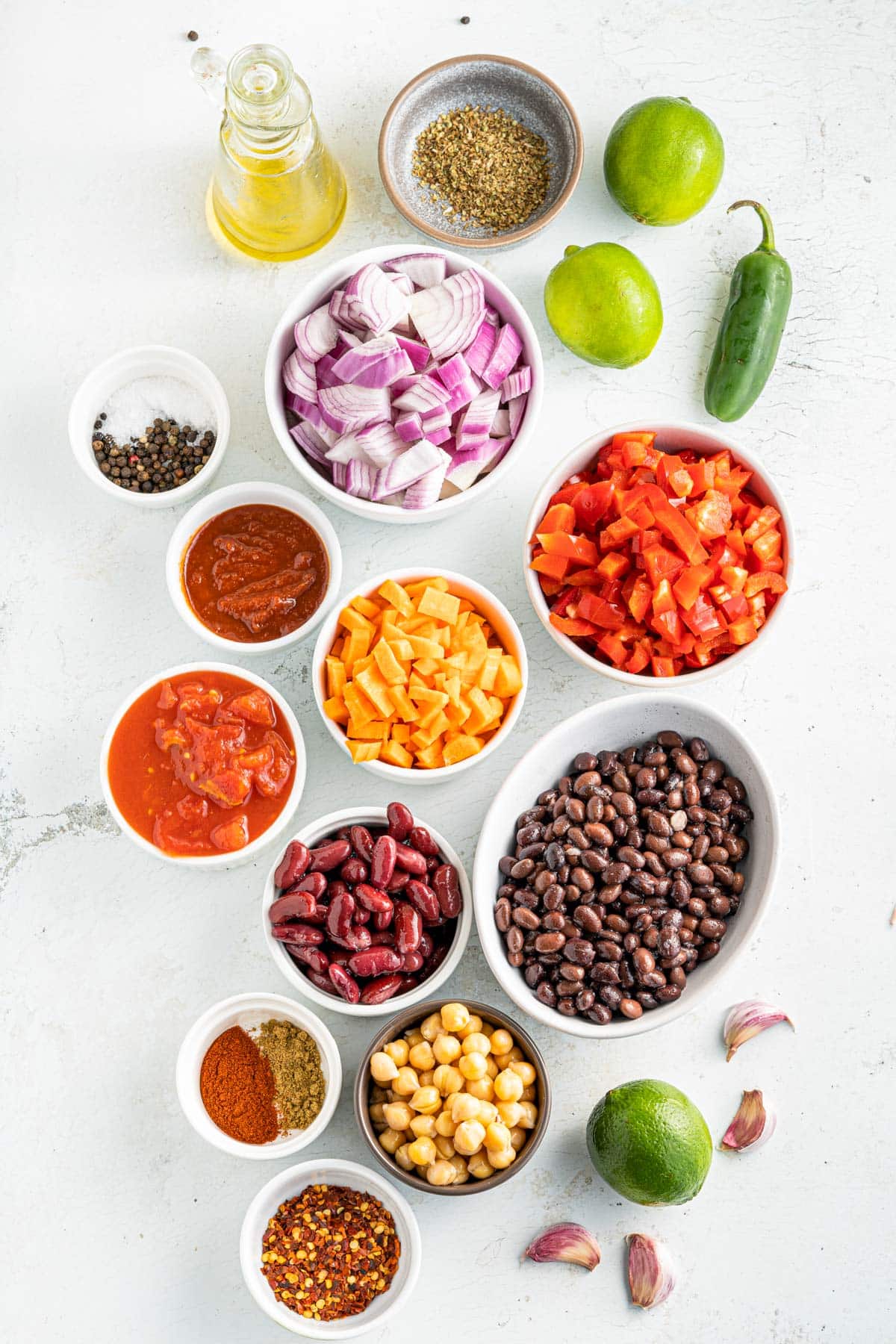 vegetarian smoky chili ingredients including black beans, chickpeas, peppers, kidney beans and spices