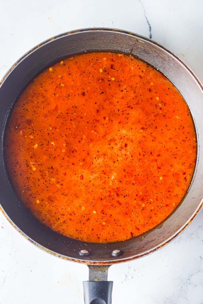 heating sweet chili wing sauce in a pan
