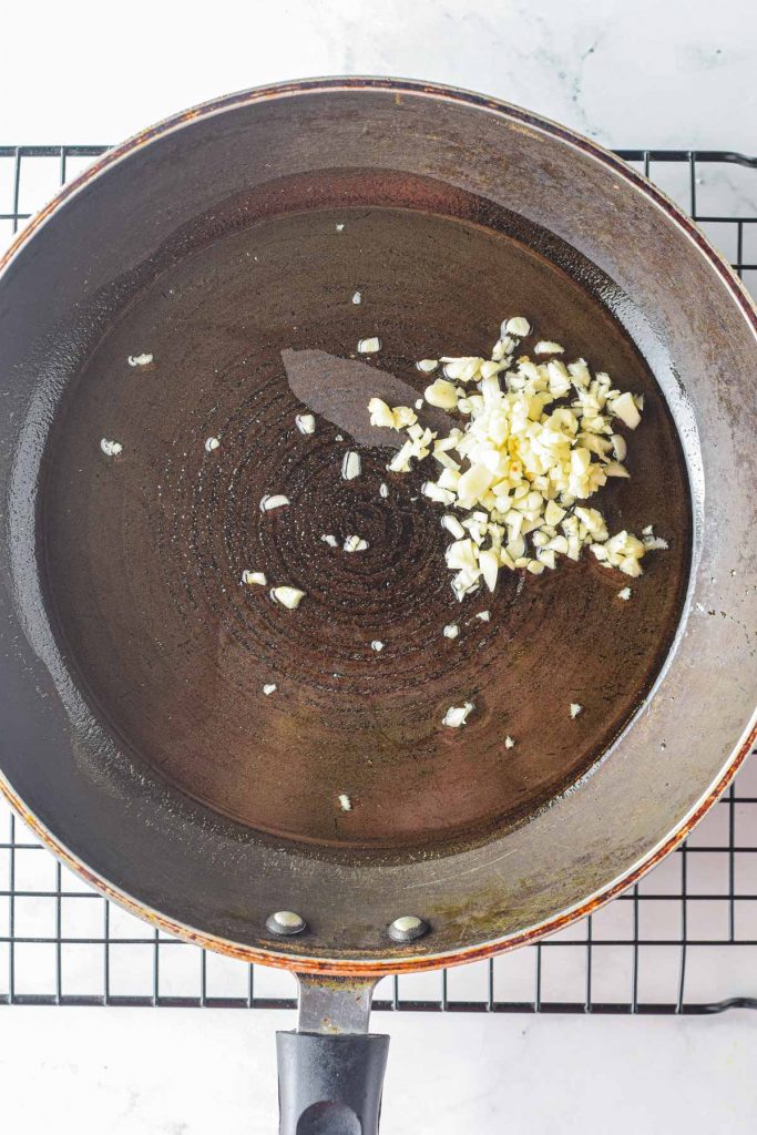 sautéing garlic in a frying pan