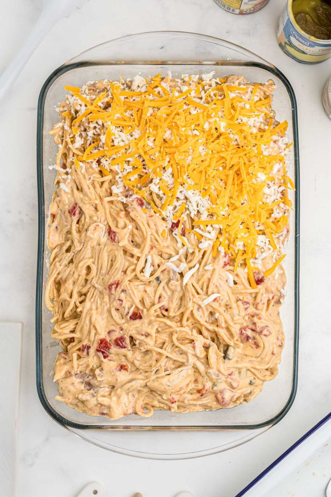 creamy chicken bake in a casserole dish topped with cheddar and mozzarella cheeses