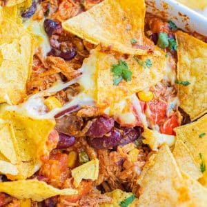 cheesy Doritos with chicken, beans, cilantro and tomatoes