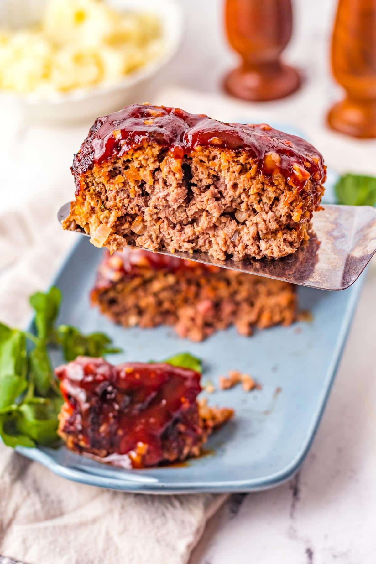 air fryer meatloaf piece lifted with a spatula