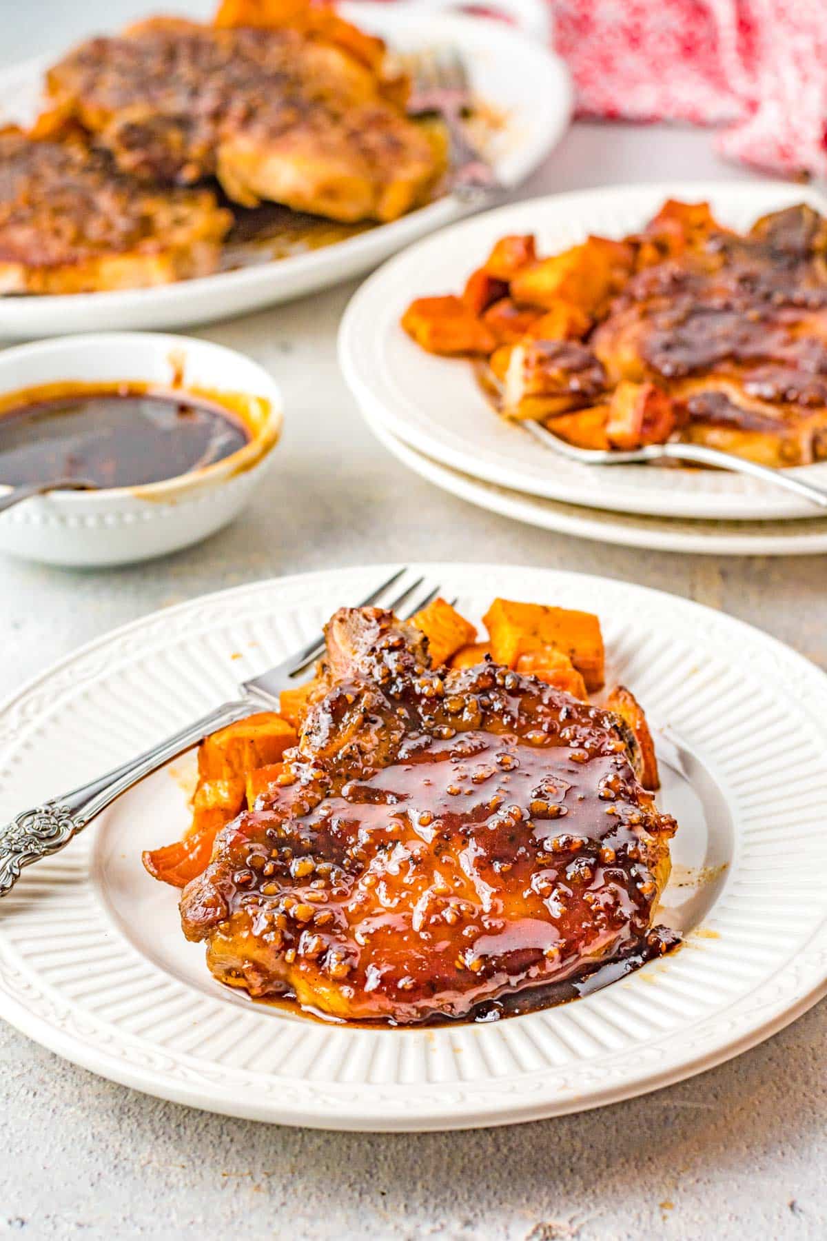 pork chops with bowl of maple bourbon glaze