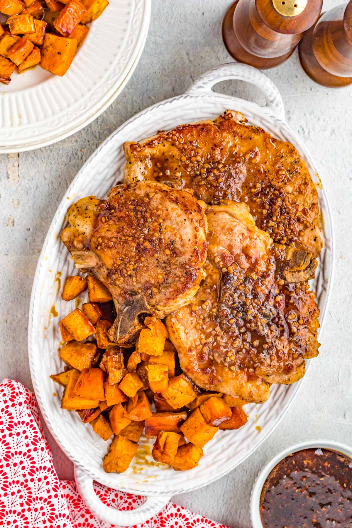 platter with pork chops and roasted sweet potato 