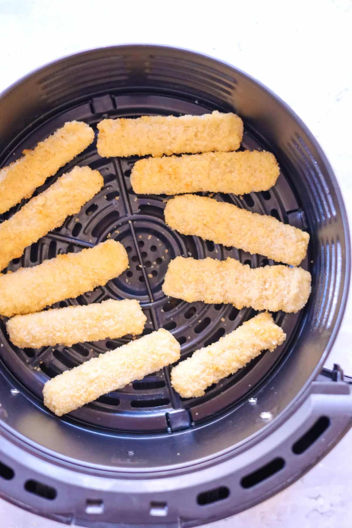 frozen fish sticks in an air fryer basket