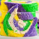Mardi Gras cake roll filled with cinnamon cream cheese frosting