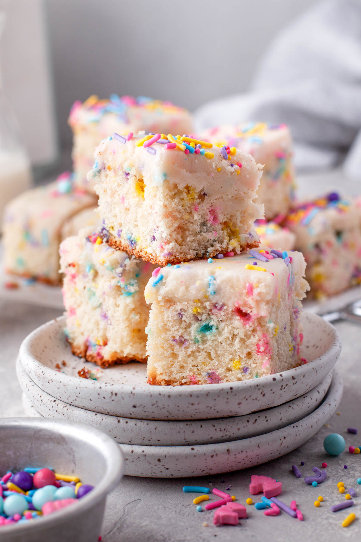 stack of three pieces of funfetti cake with sprinkles on the table