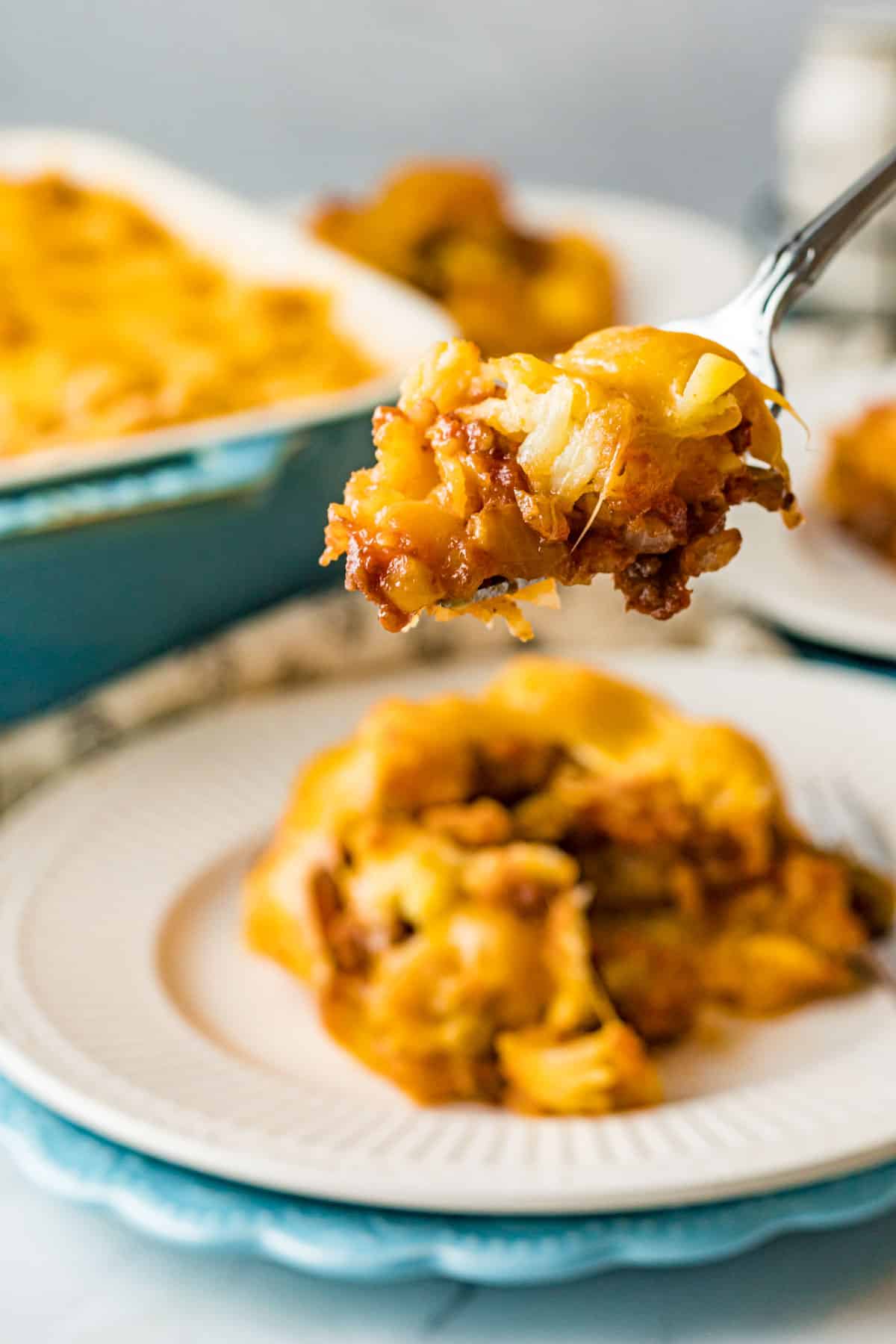 fork scooping up a bite of sloppy joe casserole with tater tots